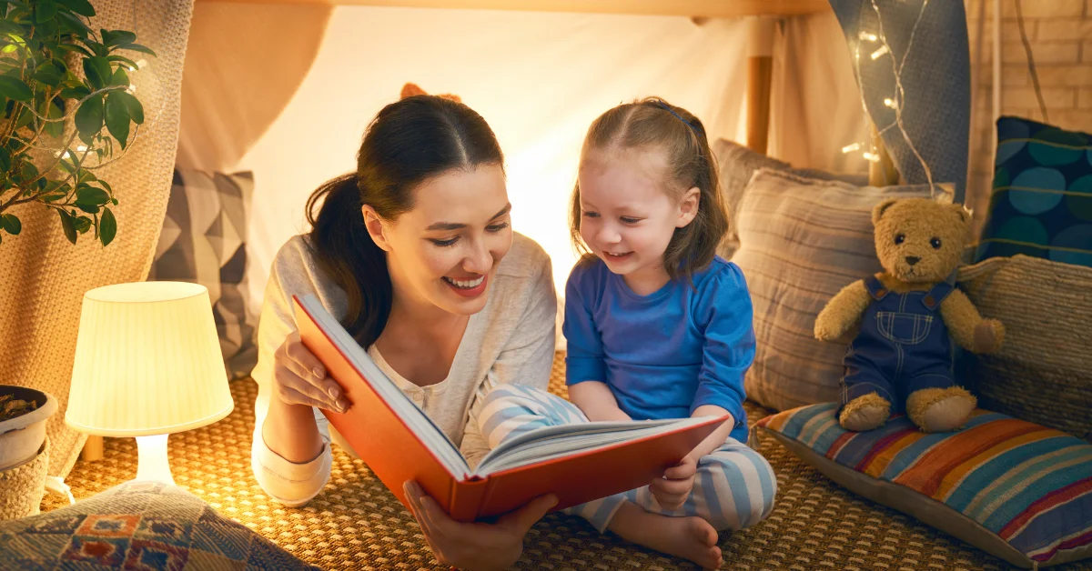 Child reading books with adult
