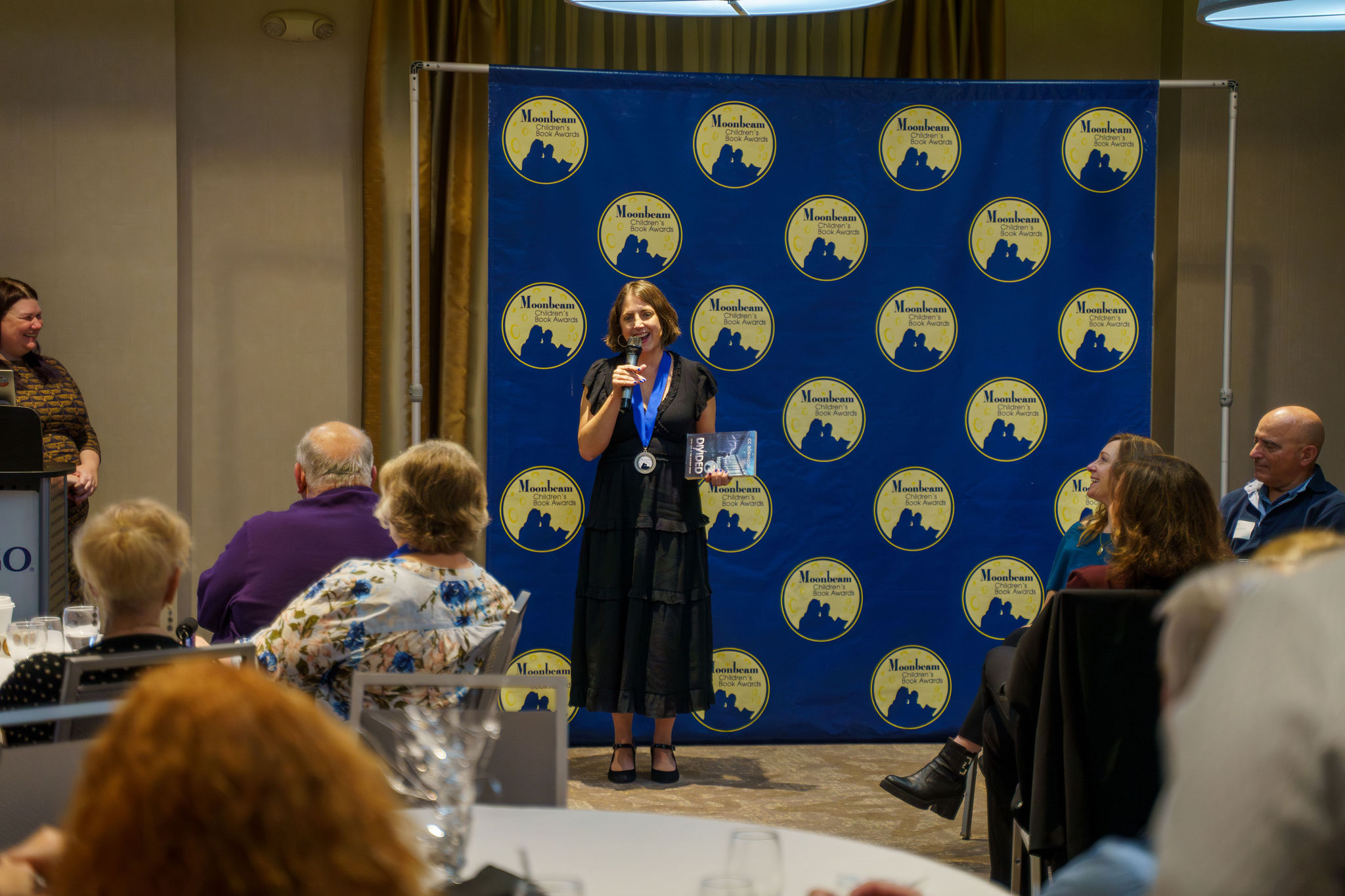 A Moonbeam medalist giving their acceptance speech at the in-person celebration in Traverse City, Michigan